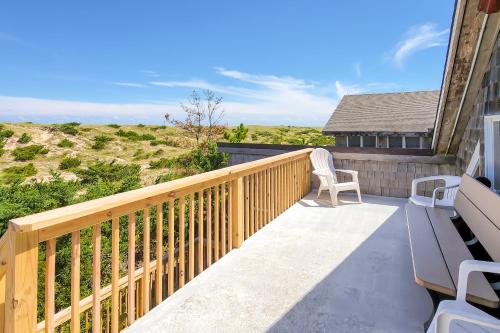 a balcony with a wooden railing and a chair at Piper's Nest AV927 in Avon