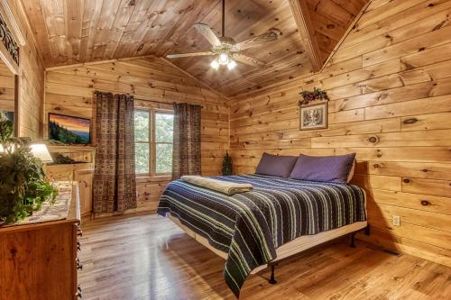 een slaapkamer met een bed in een blokhut bij Awesome Honey Bear- Get 951 worth of FREE area attraction tickets for each paid day!!! in Sevierville