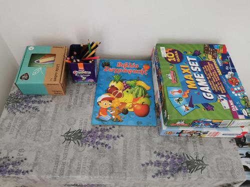 a table topped with two boxes of cereal and books at Teslić Apartman NiA in Teslić