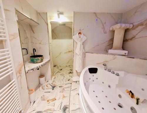 a white bathroom with a tub and a sink at Châtellerie De Schoebeque in Cassel