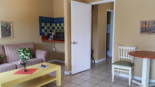 a living room with a couch and a table at Lakeside Inn and Cafe in Saint Cloud
