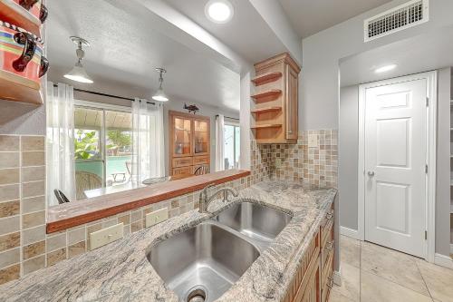 uma cozinha com um lavatório e um espelho em Aloha Condo em Padre Island
