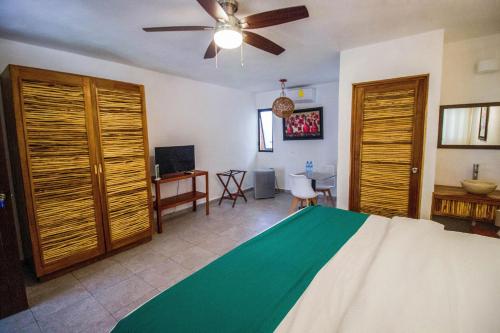 - une chambre avec un lit et un ventilateur de plafond dans l'établissement Hotel Tequila Cancun, à Cancún