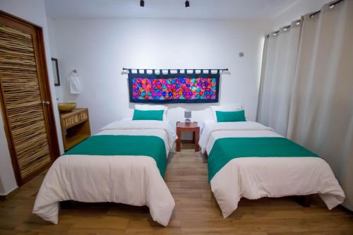 a bedroom with two beds and a window at Hotel Tequila Cancun in Cancún