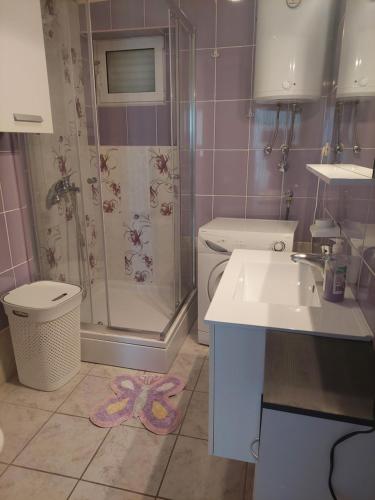 a bathroom with a shower and a toilet and a sink at The Look in Mali Lošinj