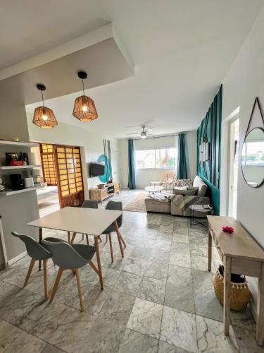 a living room with a table and a couch at TAHITI - Orovini Cottage in Papeete