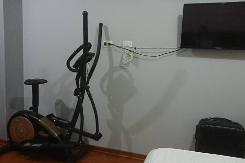 a room with a exercise bike and a television at Elegante Flat en inmejorable ubicación - San Isidro in Lima