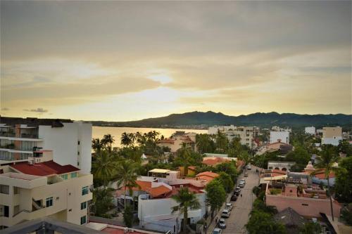 an aerial view of a city with a river and buildings at Steps from the Beach Condo Life Bucerias Golden Zone in Bucerías