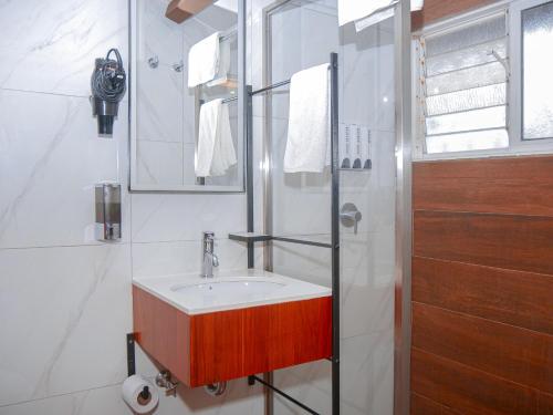 a bathroom with a sink and a shower at Sangay Spa Hotel in Baños