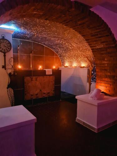 a dark room with a brick wall with lights at Châtellerie De Schoebeque in Cassel
