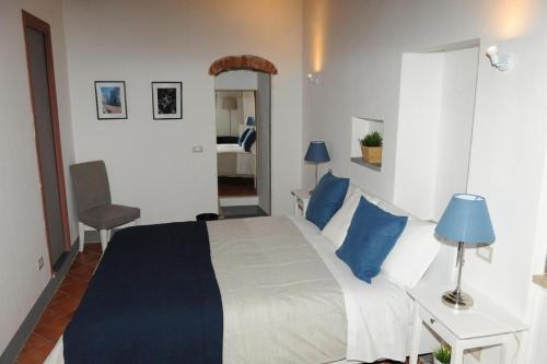 a bedroom with a large bed with blue pillows at Condotta3Rooms in Florence