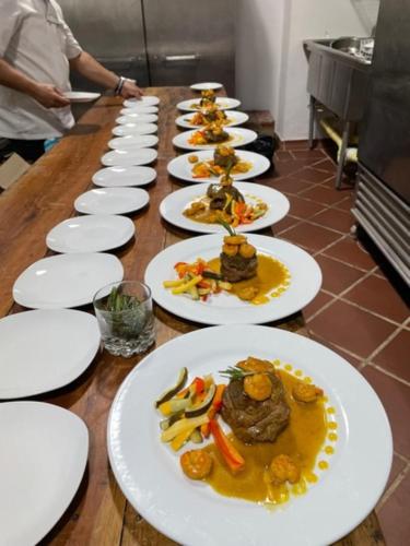 a row of plates of food on a table at Karakali Boutique Hotel in Mompos