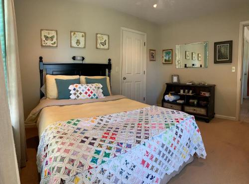 a bedroom with a bed with a quilt on it at Red Tail Ranch in Groveland
