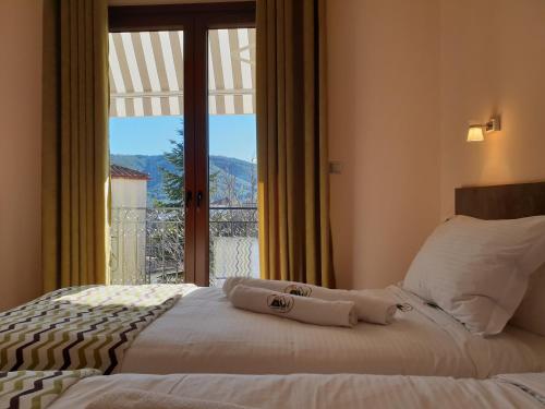 a bedroom with a bed and a large window at Mondeus Inn Luxury 