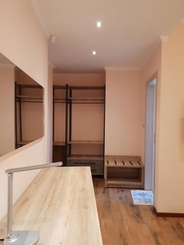 a room with a closet with a wooden table at Mondeus Inn Luxury in Deskáti