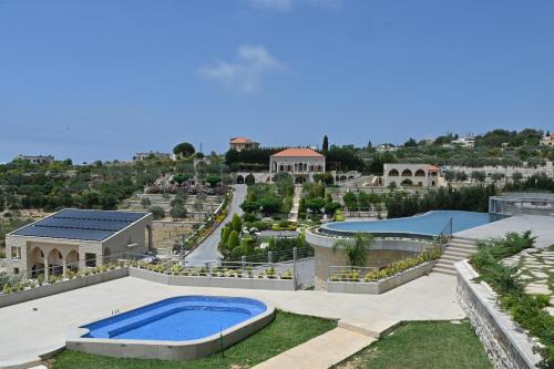 an aerial view of a resort with a swimming pool at Domaine des Oliviers in Batroûn