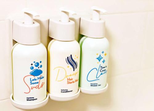 four bottles of cleaning products sitting on a shelf at Sonesta Select Seattle Renton Suites in Renton