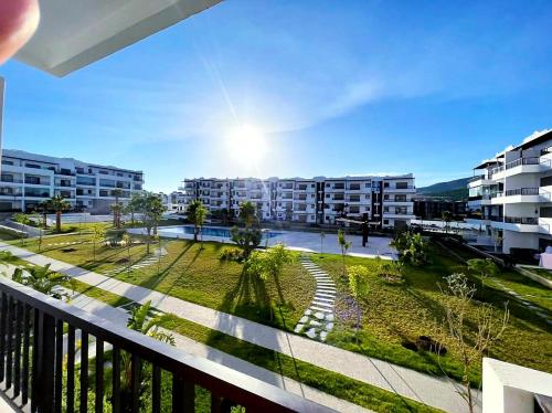 a balcony with a view of a park and buildings at appartement haut standing en résidence Cabo Huerto vue sur deux grand Piscine in Cabo Negro