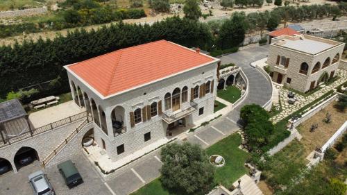 an overhead view of a large building with an orange roof at Domaine des Oliviers in Batroûn