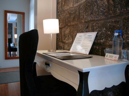 a desk with a lamp and a book on it at Sangay Spa Hotel in Baños