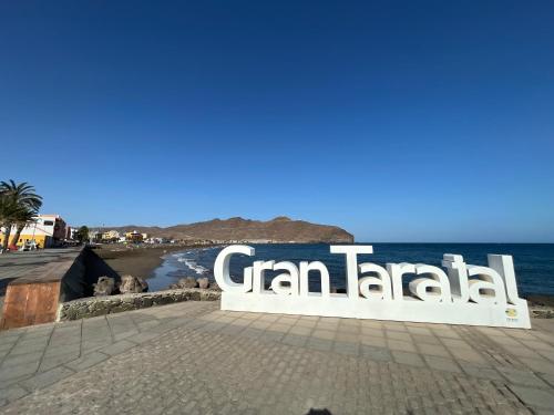 a sign for a canandal sign on a beach at Casa Mararía in Gran Tarajal