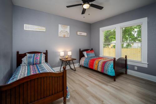 a bedroom with two beds and a ceiling fan at Spacious Home Near Downtown San Antonio in San Antonio