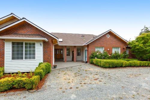 a brick house with a driveway in front of it at Arrowhead Way in Utsalady