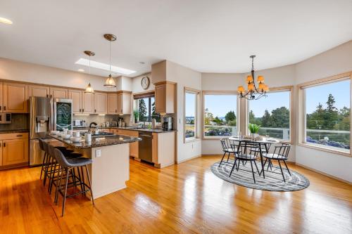 an open kitchen with wooden floors and windows at Arrowhead Way in Utsalady