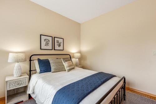 a bedroom with a bed with blue and white sheets at Arrowhead Way in Utsalady