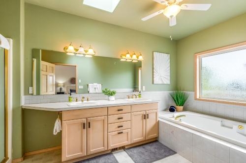 a bathroom with a tub and a large mirror at Arrowhead Way in Utsalady