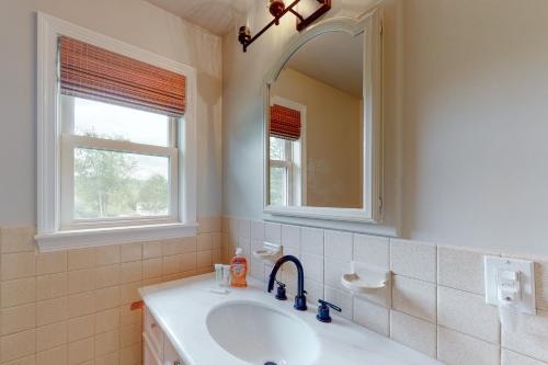 a bathroom with a sink and a mirror at Randall Meadows in Pittsford