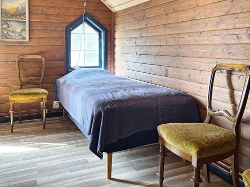 1 dormitorio con 1 cama y 2 sillas en Holiday home ÖRSJÖ, en Örsjö