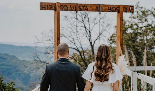 a bride and groom walking down the aisle at their wedding at Woodland Cabins in Santa Ana Jilotzingo