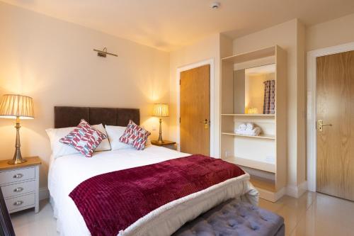 a bedroom with a large bed with two pillows at The Merry Monk in Ballina