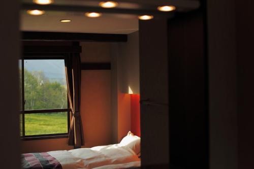 Ένα ή περισσότερα κρεβάτια σε δωμάτιο στο Hotel Hakuba Berghaus