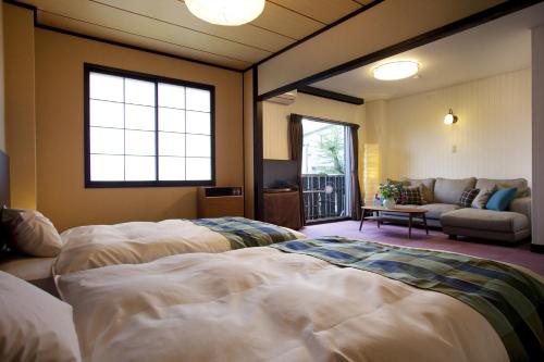 Ένα ή περισσότερα κρεβάτια σε δωμάτιο στο Hotel Hakuba Berghaus