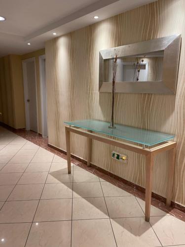 a table with a glass top in a room at Kreoli Hotel in Athens