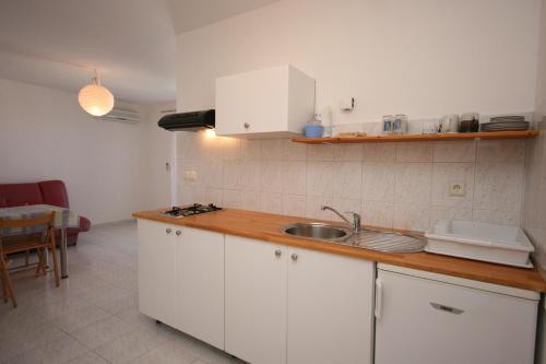 a kitchen with a sink and a counter top at Apartment Mandre 6405b in Kolan