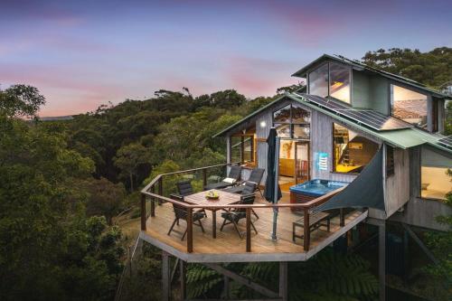 an overhead view of a tree house with a table and chairs at The Oasis Apartments and Treetop Houses in Byron Bay