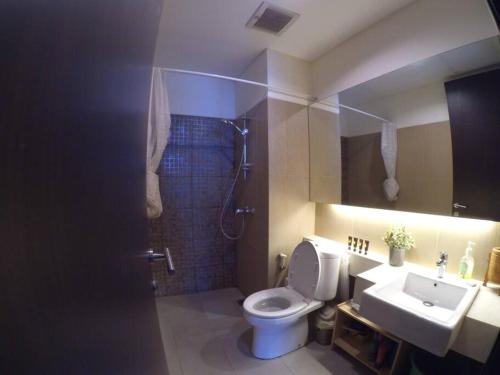 a bathroom with a toilet and a shower and a sink at Strategic Cozy Hang Out Apartment, GP Plaza in Jakarta