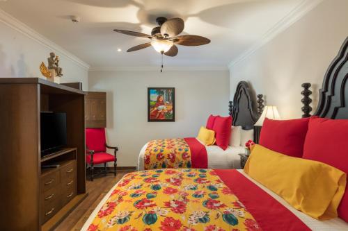 a bedroom with two beds and a ceiling fan at Vista Encantada Resort & Spa Residences, A La Carte All Inclusive Optional in Cabo San Lucas