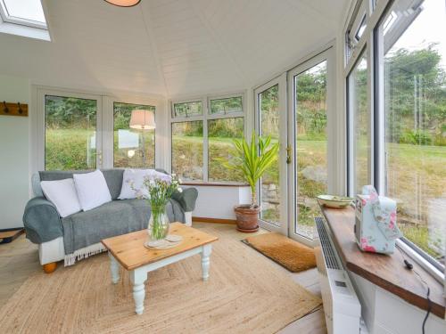a living room with a couch and a table at Kestorway in Gidleigh