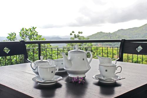 a group of tea sets sitting on a wooden table at AHAS GAWWA Boutique in Padukka