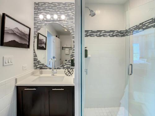 a bathroom with a shower and a sink and a mirror at Pet Friendly in Orlando area near Disney in Orlando