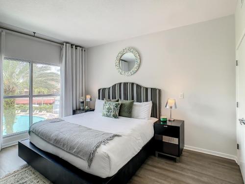 a bedroom with a large bed and a large window at Pet Friendly in Orlando area near Disney in Orlando