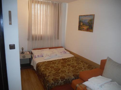 a small bedroom with a bed and a chair at Apartments with a parking space Mareda, Novigrad - 7100 in Novigrad Istria