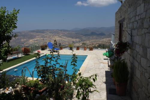 a swimming pool with a view of the mountains at Georgia's House in Paphos