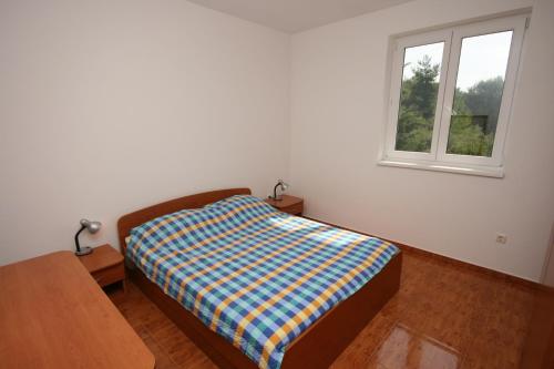 a bedroom with a bed and a window at Apartments with a parking space Novigrad - 7017 in Novigrad Istria
