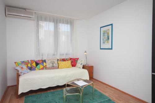 a white room with a bed and a chair at Apartments with a parking space Zambratija, Umag - 7059 in Zambratija