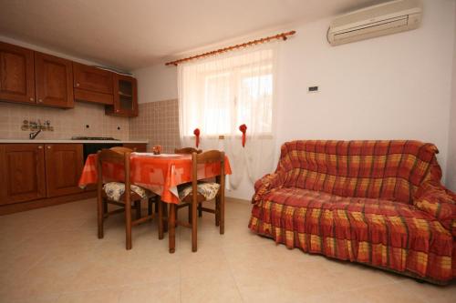 a living room with a table and a couch at Apartments by the sea Zambratija, Umag - 7030 in Zambratija